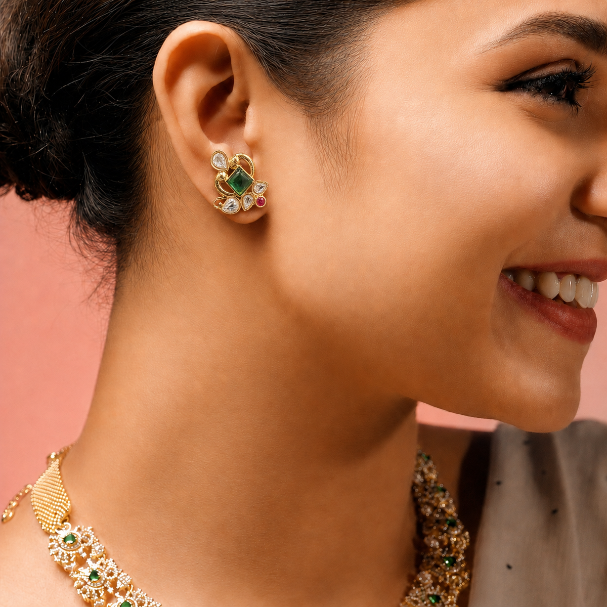 Compact gold-finished floral stud earrings with green, ruby-pink and clear Polki-style stones—ideal for festive and wedding wear.